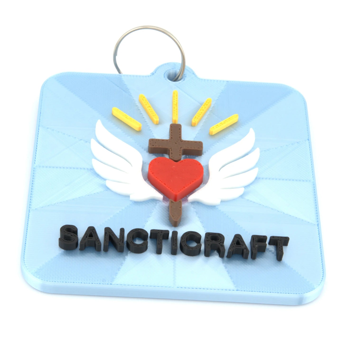 Christian winged heart and cross keychain close up