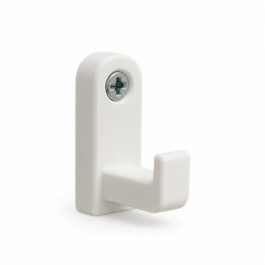 White minimal wall hook with a rounded backplate, mounted by the door