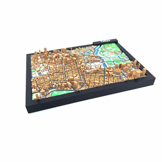Framed 3D Tokyo city map showing dense building clusters and neighborhoods in miniature