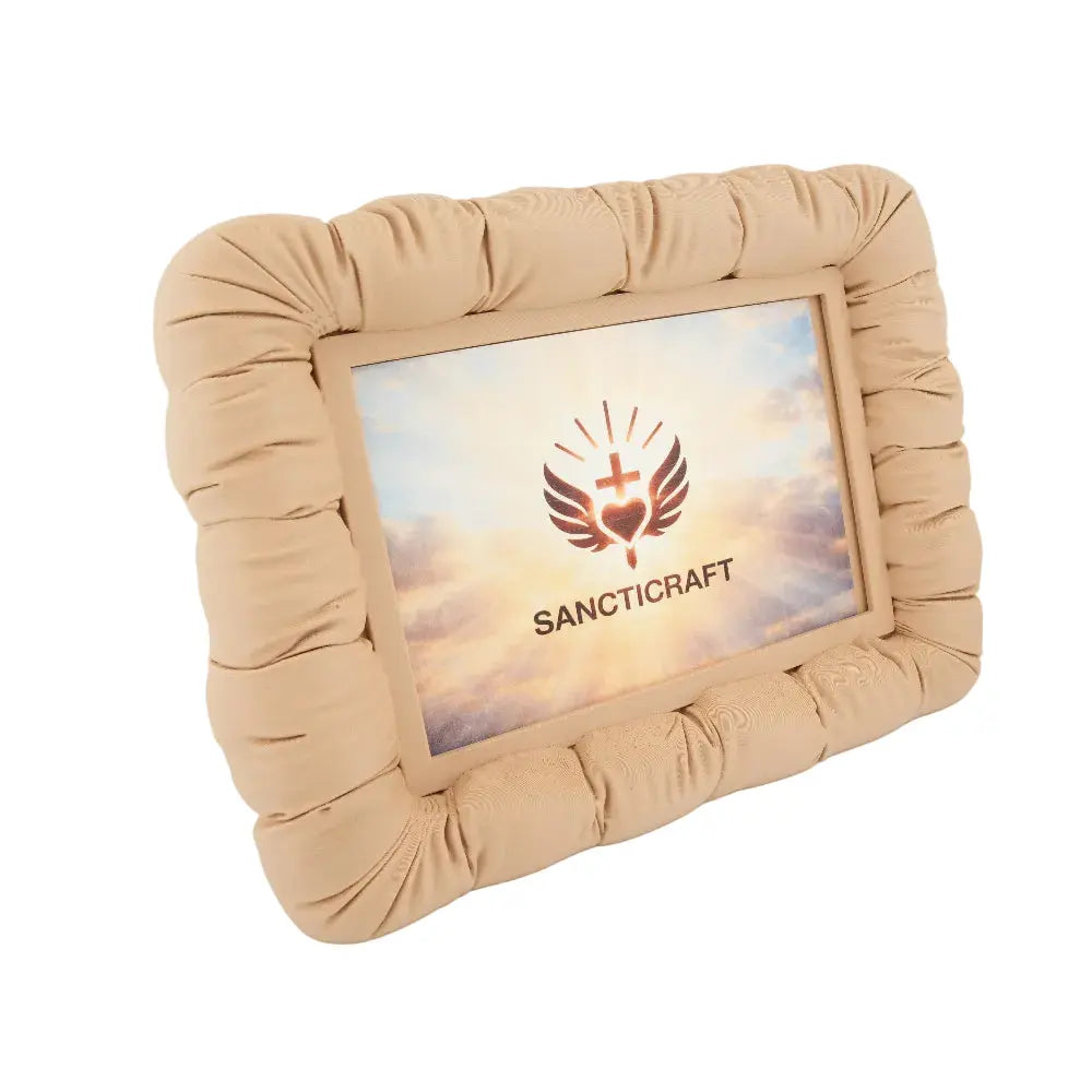 Couch-shaped photo frame holding a small printed photo on a desk