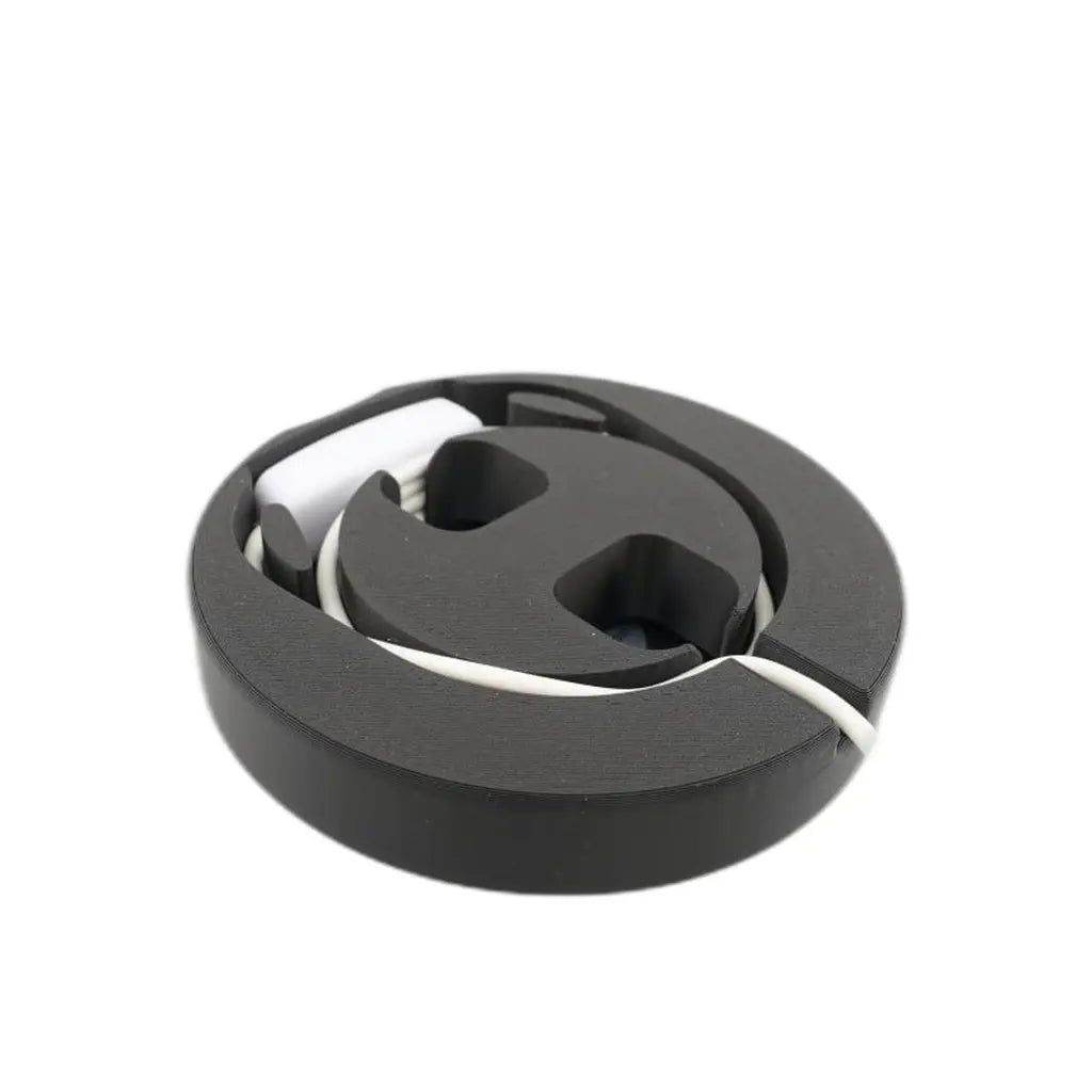 Black lamp base with the cord coiled into the channel inside, hiding the cable