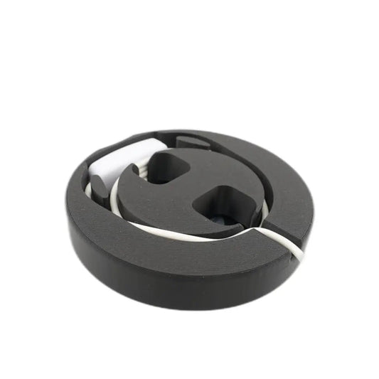 Black lamp base with the cord coiled into the channel inside, hiding the cable