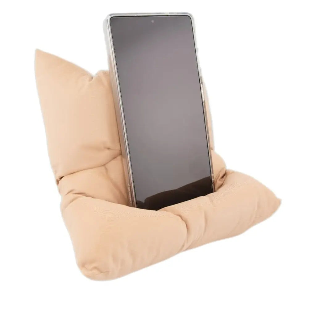 Cream cushion-shaped phone stand holding a smartphone upright