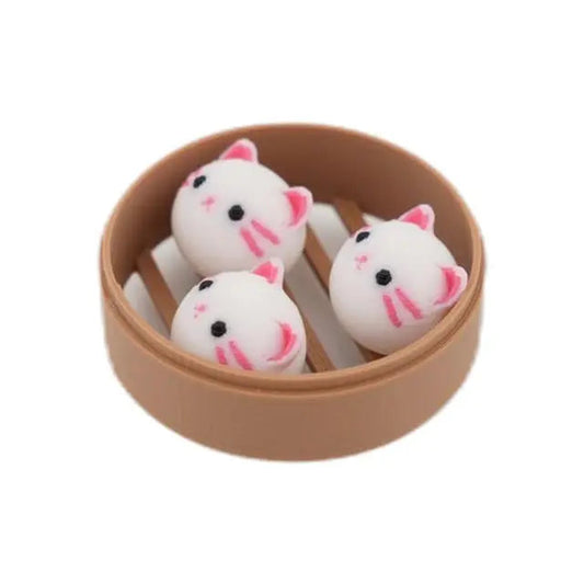 Fridge magnet shaped like three small cats in a dim sum steamer basket