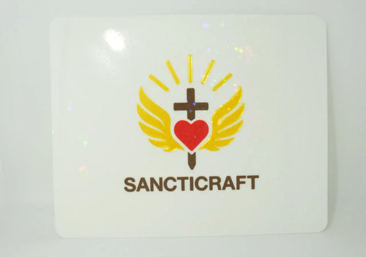 White mousepad with a holographic star overlay and a gold winged heart and cross logo